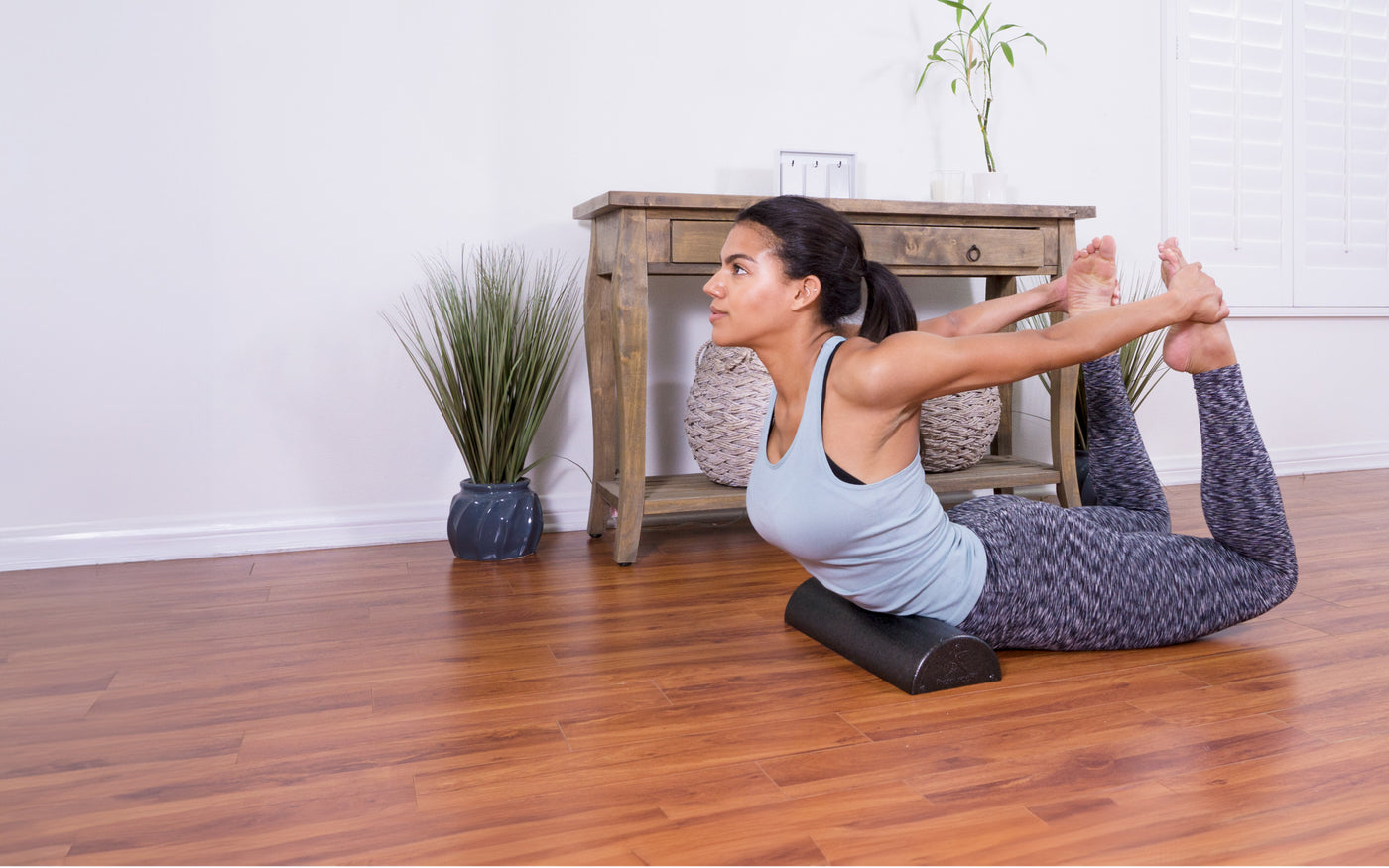 Women on floor stretching with the ProsourceFit High Density Half Round Foam Roller