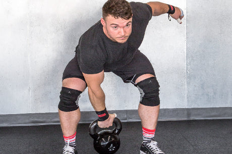 man using prosourcefit cast iron kettlebell for crossfit