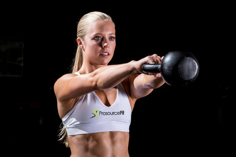 Fit woman working out with ProsourceFit Cast Iron Kettlebell