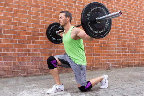 man doing walking lunges with prosourcefit barbell and bumper plates