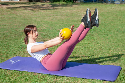 Woman using prosourcefit extra thick yoga and pilates mat 1/2" inch with prosourcefit toning balls for v-ups