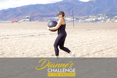 woman with medicine ball working out on beach