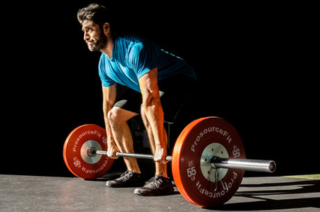 man using prosourcefit barbell and prosourcefit color training bumper plates