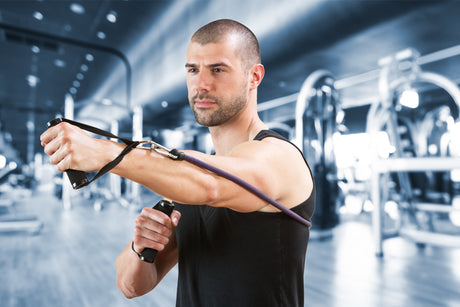 man using resistance band in a gym